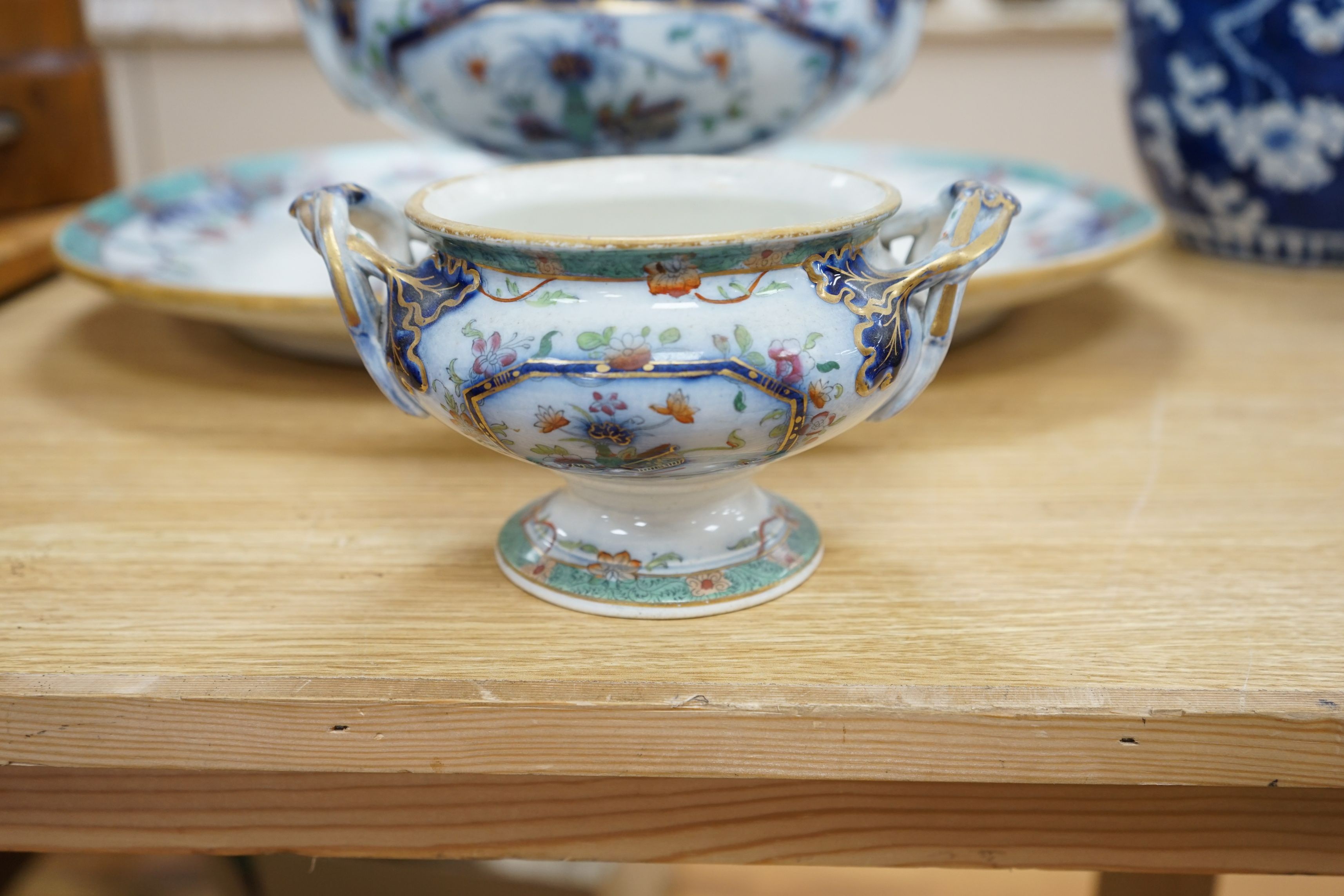 A mid 19th century Staffordshire pottery lidded soup tureen and cover (base cracked), a large meat dish and a sauce tureen (lacking lid) (3)